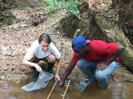Martinique Edwards and a classmate sampling a stream in the freshwater Ecosystems class, Fall 2016. Photo: Martinique Edwards.