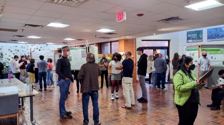 Odum School of Ecology students and faculty gather in the Odum lobby to view the undergraduate posters on display at the 28th annual Ecology Graduate Student Symposium in February 2022. Photo: Dean Sonia Altizer.