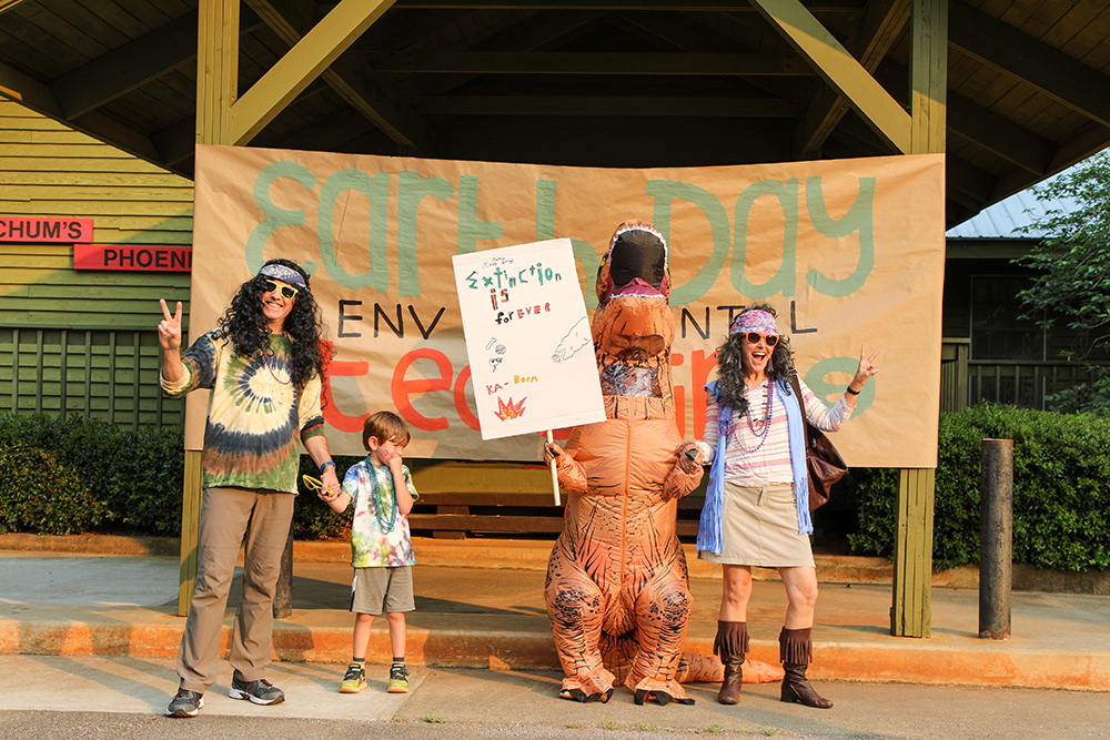 The "Hippie Dippie" family stands in front of a banner reading "Earth Day Environmental Teach-In" at Flinchum's Phoenix. Photo: Ben Taylor.