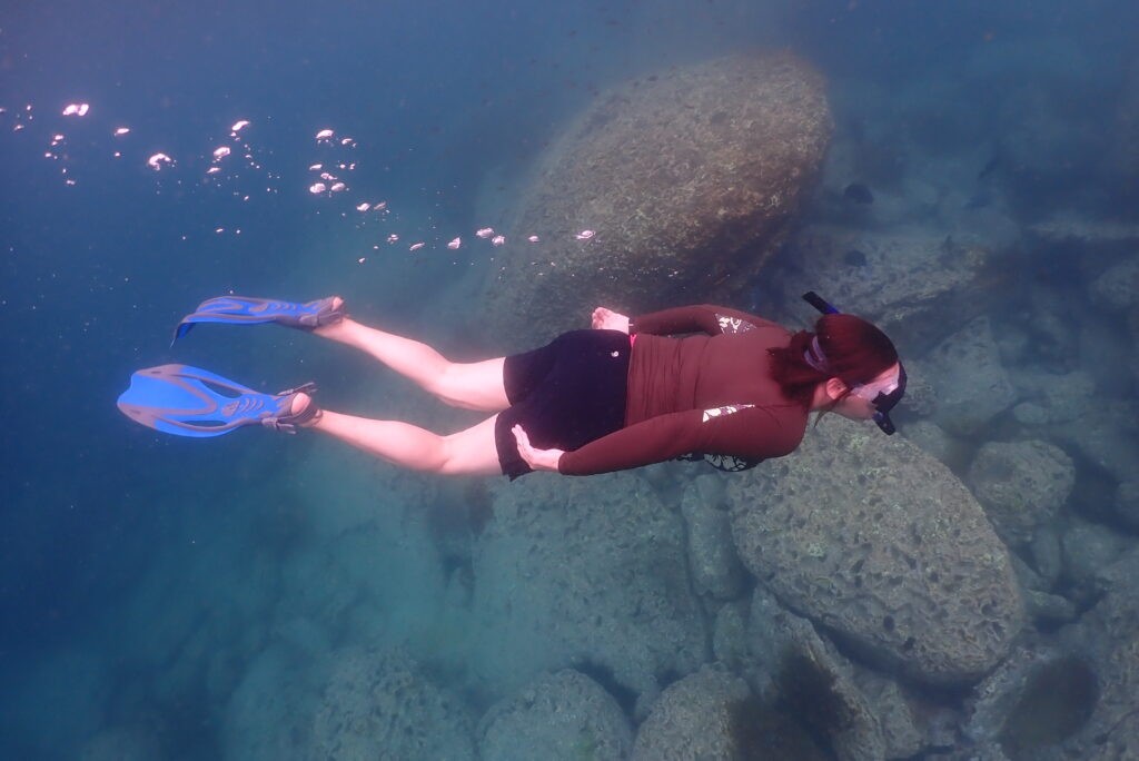 person with snorkel and fins underwater