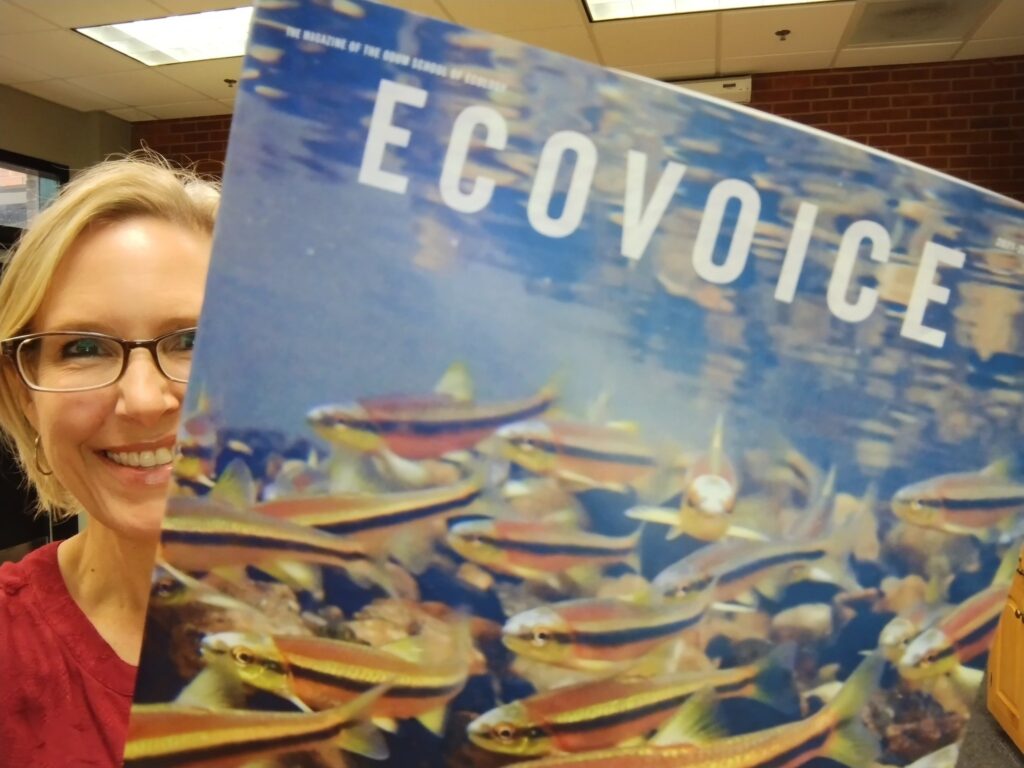 Dean Altizer holding EcoVoice magazine