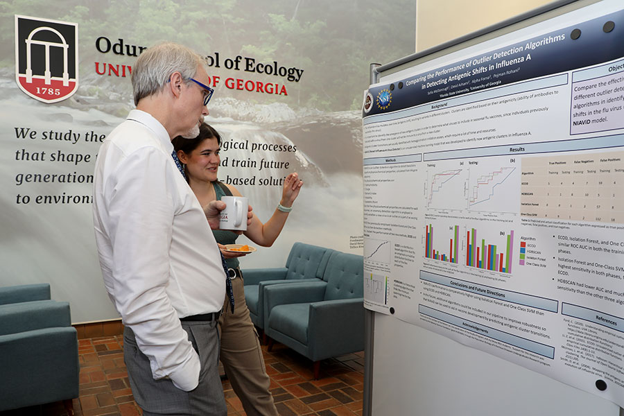 Dean Mark Hunter of the UGA Odum School of Ecology talks with Sofia McDonough about her research poster.